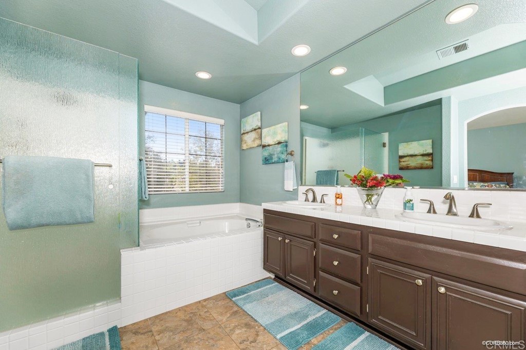 1840 Century Way Escondido, CA 92026 - Photo 24 of 36 a bathroom with a tub double vanity sink and mirror
