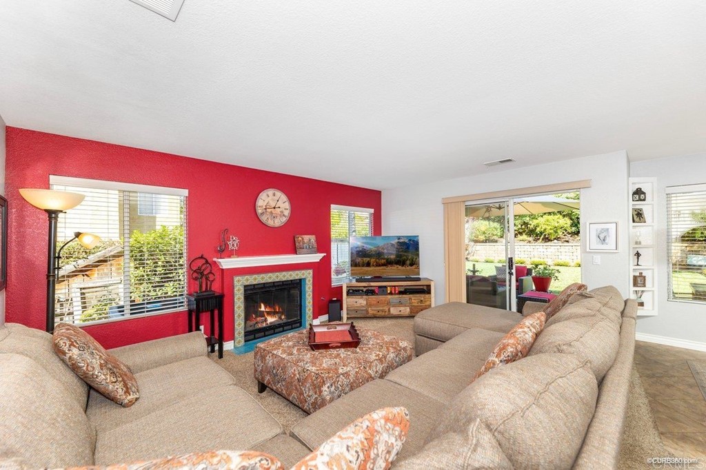 1840 Century Way Escondido, CA 92026 - Photo 4 of 36 a living room with furniture a fireplace and a large window