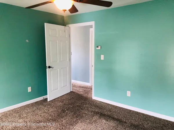a view of a room with a fan and a window