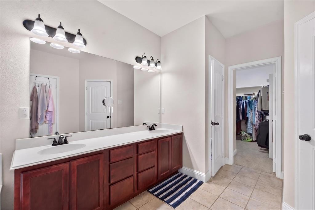 517 Austin Acre Road Sulphur Springs, TX 75482 - Photo 17 of 23 a bathroom with a double vanity sink and a mirror