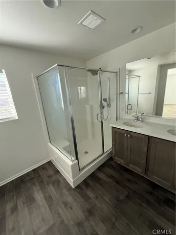 a view of bathroom with sink mirror and window