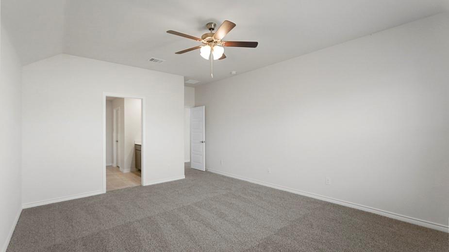 439 Epiphany Lane Lavon, TX 75166 - Photo 19 of 31 Spacious room featuring vaulted ceilings, neutral-toned carpeting, and a ceiling fan with integrated lighting
