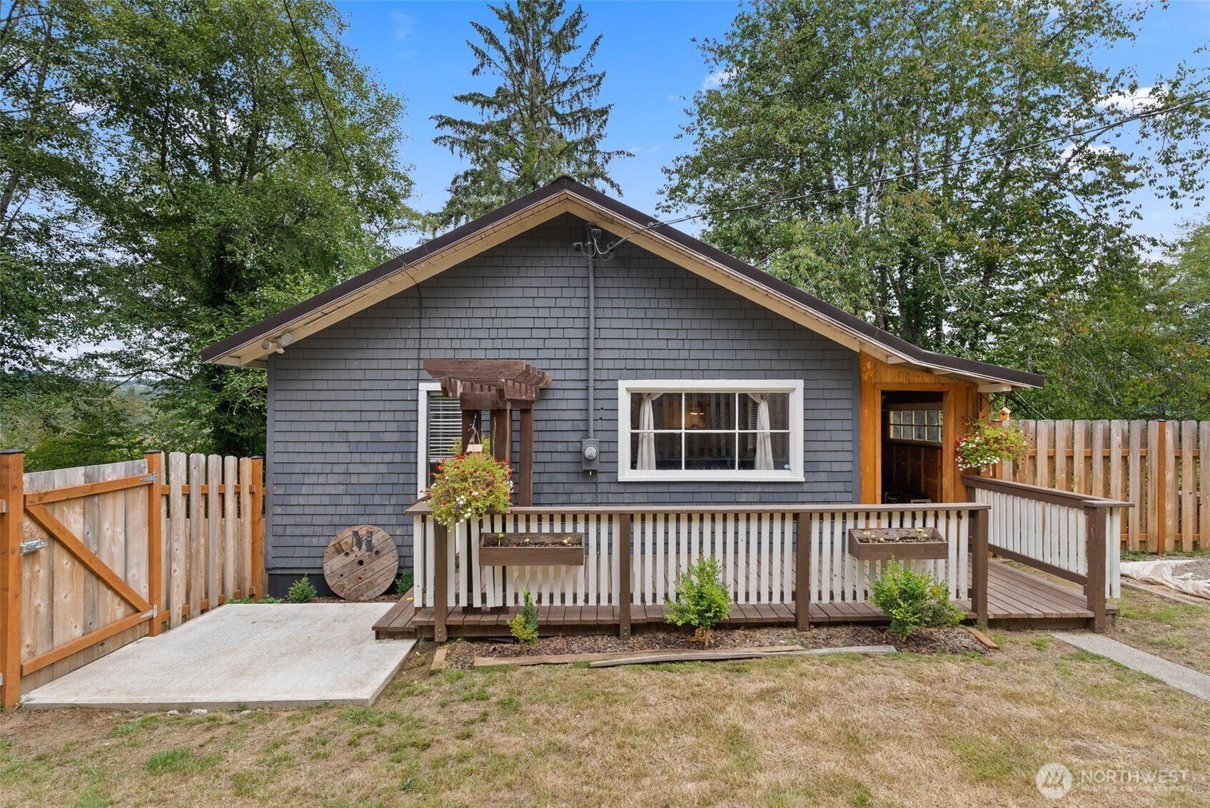 a view of a house with a small yard and wooden fence