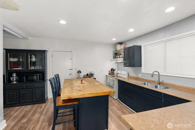 a kitchen with a sink cabinets and window