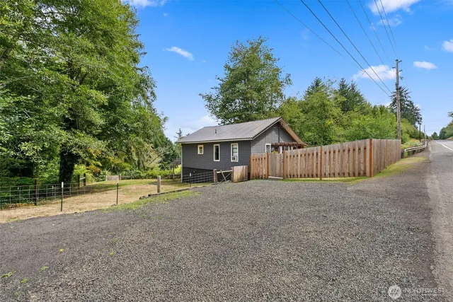 a view of house with backyard and deck