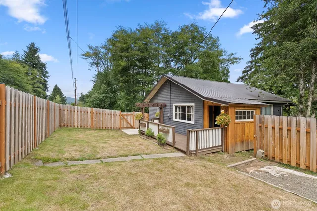 a view of a house with wooden fence and a fence