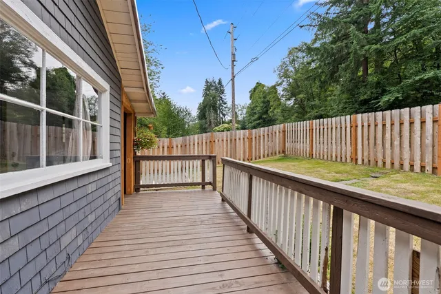 a view of balcony with wooden floor and fence