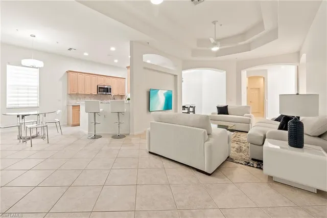 a kitchen with kitchen island granite countertop a sink appliances cabinets and furniture