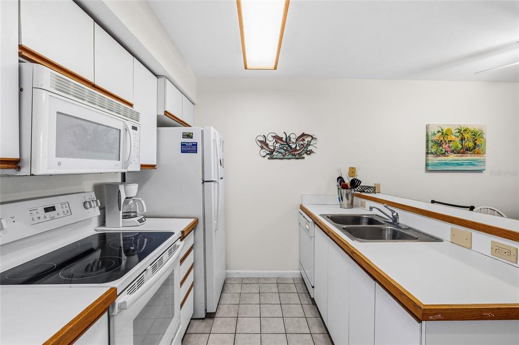 9400 Little Gasparilla, Unit F7 Placida, FL 33946 - Photo 11 of 39 a kitchen that has a sink and a stove