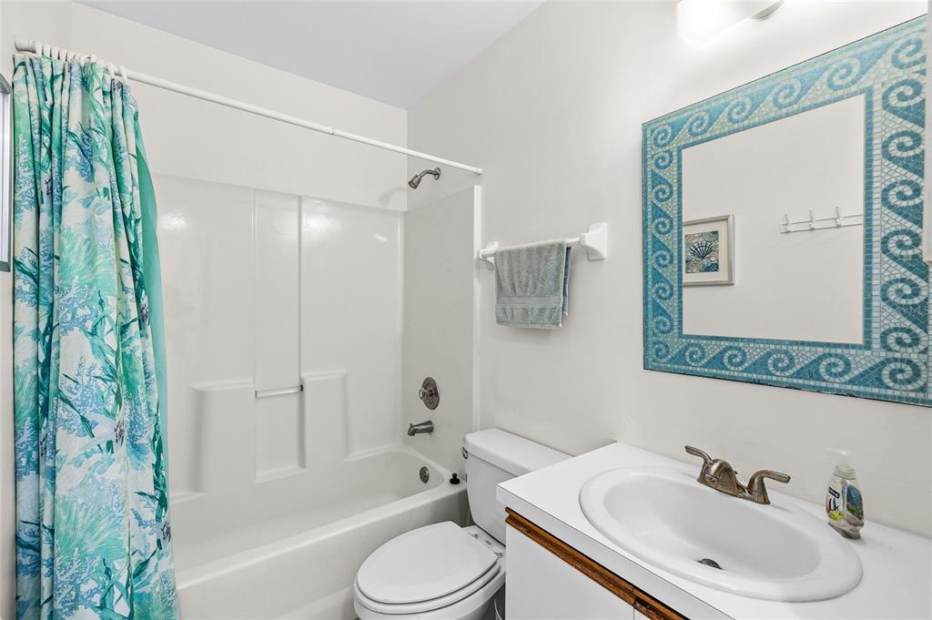 9400 Little Gasparilla, Unit F7 Placida, FL 33946 - Photo 15 of 39 a bathroom with a sink toilet and shower