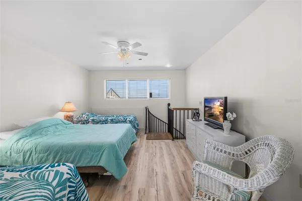 a bedroom with a bed and a chair