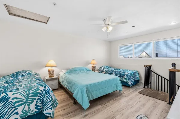 a bedroom with two beds and a chandelier