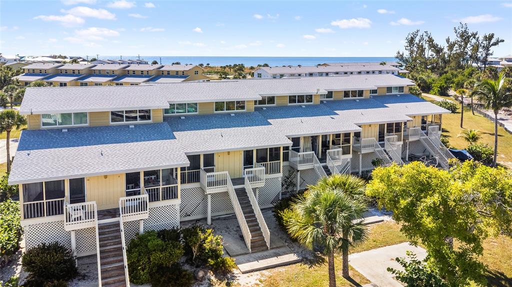 9400 Little Gasparilla, Unit F7 Placida, FL 33946 - Photo 30 of 39 a view of a house with a yard and sitting area