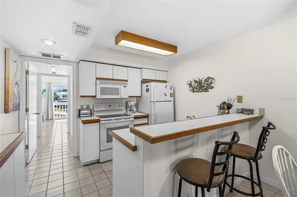a kitchen with stainless steel appliances a stove a table and chairs