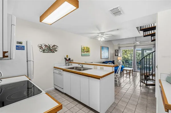 a kitchen with a sink and a stove top oven