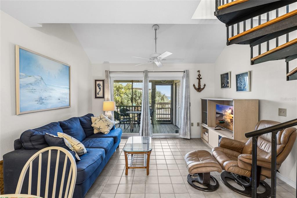 9400 Little Gasparilla, Unit F7 Placida, FL 33946 - Photo 10 of 39 a living room with furniture a window and a chandelier