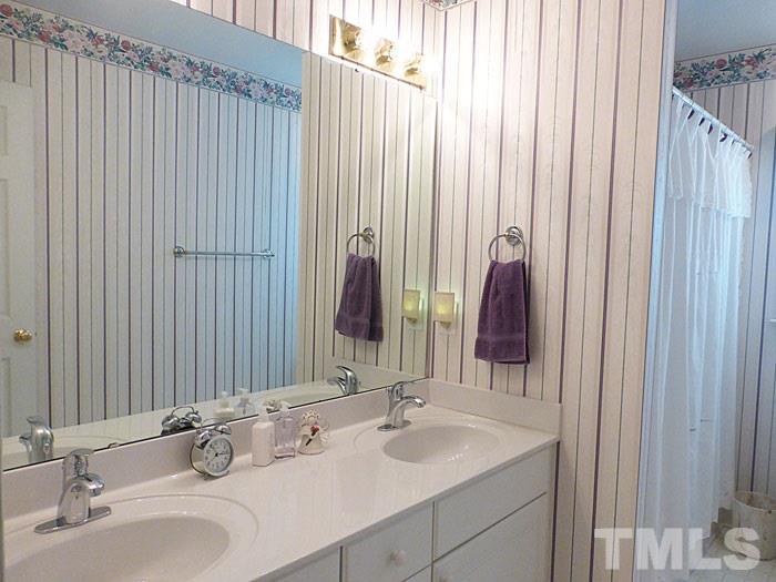 4807 Sinclair Drive Raleigh, NC 27616 - Photo 16 of 25 a bathroom with a double vanity sink and a mirror