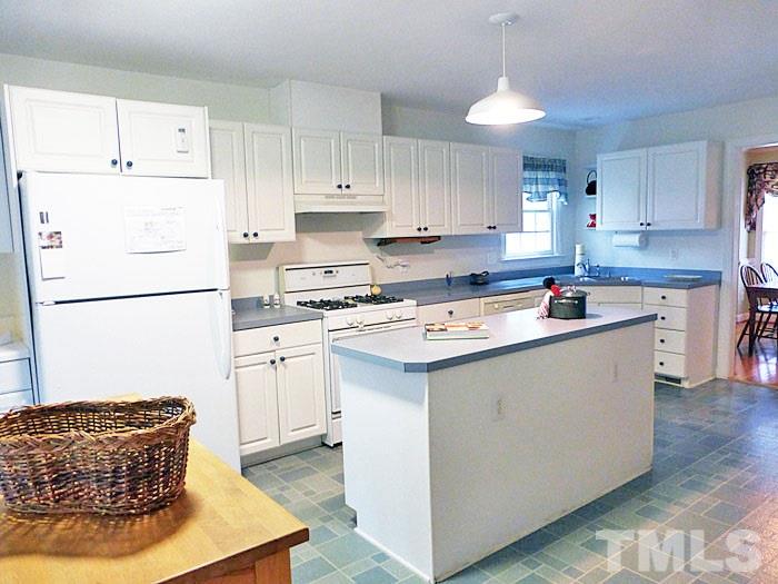 4807 Sinclair Drive Raleigh, NC 27616 - Photo 5 of 25 a kitchen with stainless steel appliances granite countertop a sink a stove a refrigerator and white cabinets