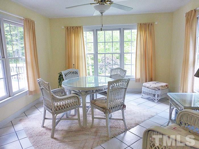 4807 Sinclair Drive Raleigh, NC 27616 - Photo 8 of 25 a dining room with furniture windows and a chandelier