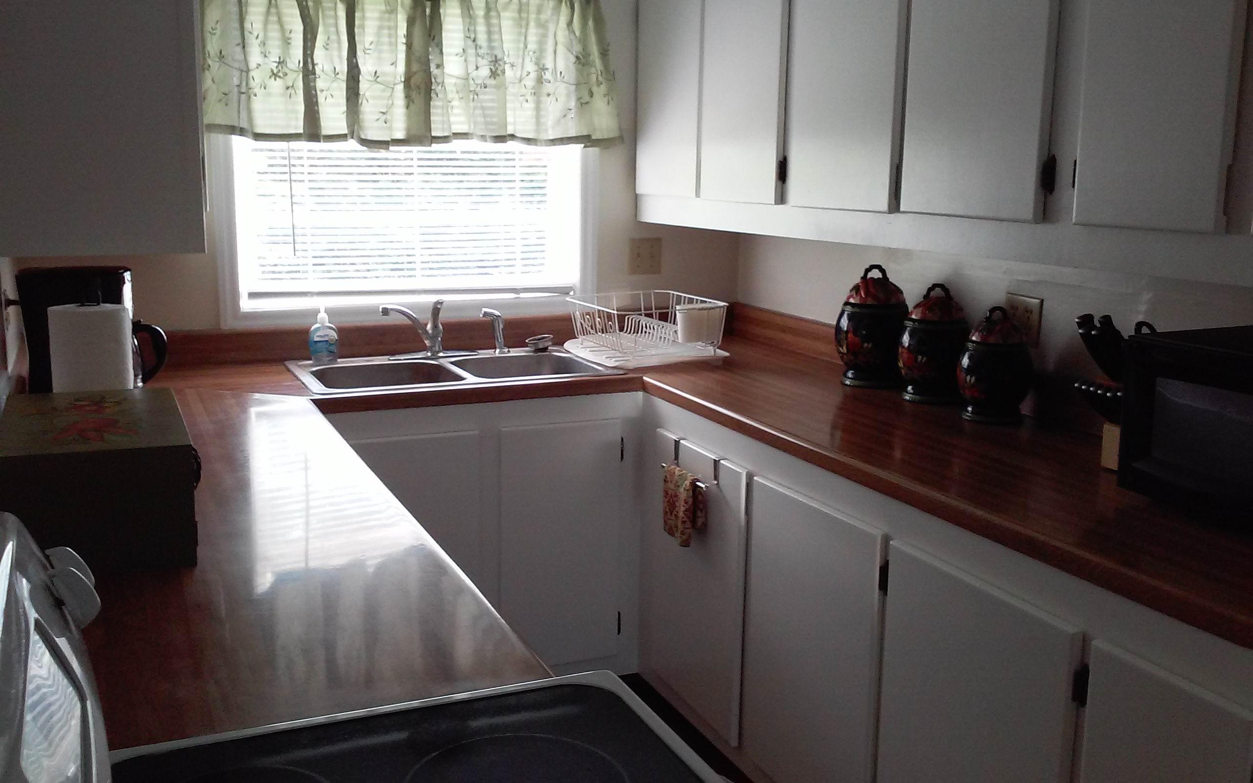 1990 Reesedale Road Elliston, VA 24087 - Photo 13 of 24 a kitchen with stainless steel appliances granite countertop a sink a stove and cabinets