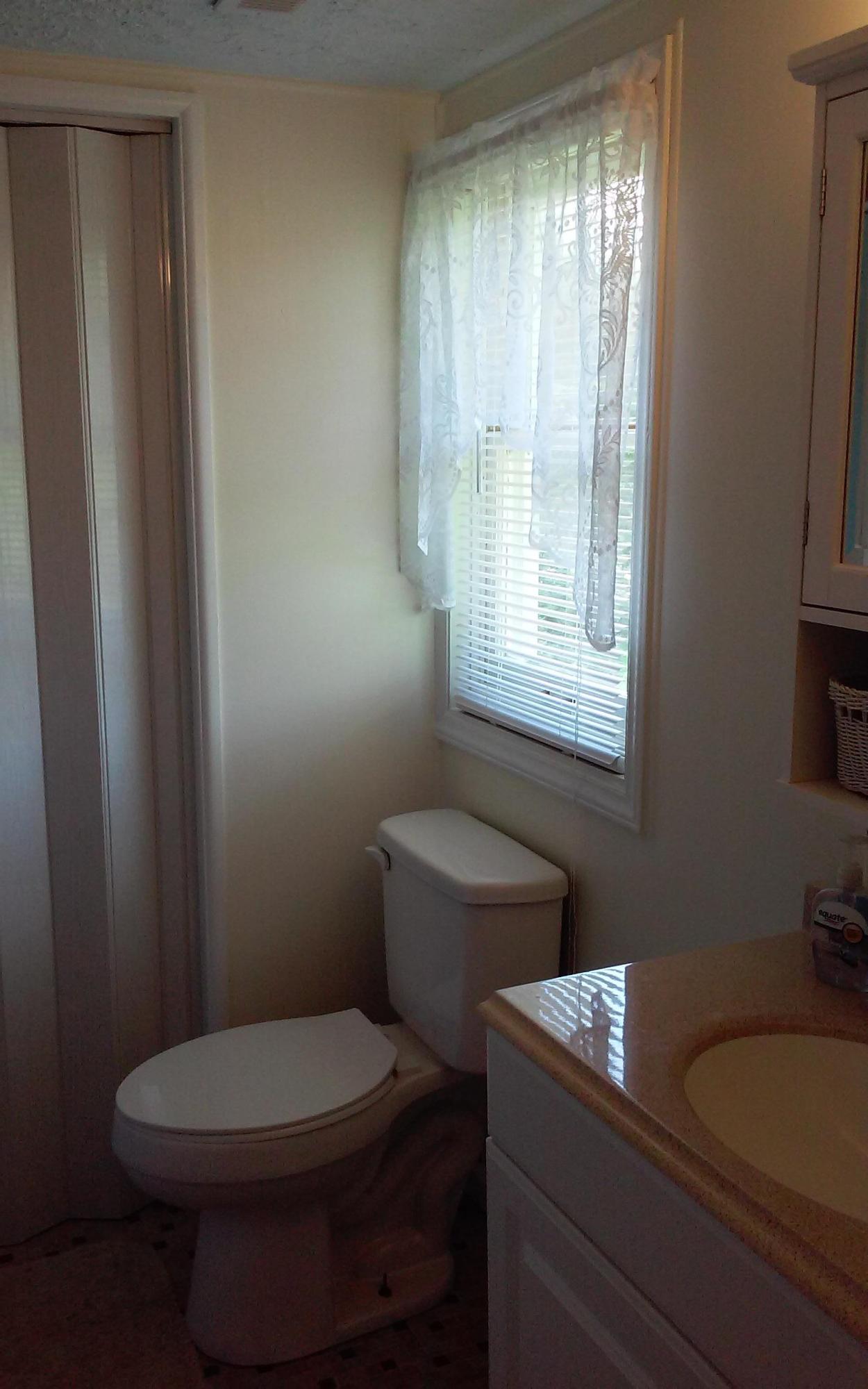 1990 Reesedale Road Elliston, VA 24087 - Photo 22 of 24 a bathroom with a granite countertop toilet a sink and a window