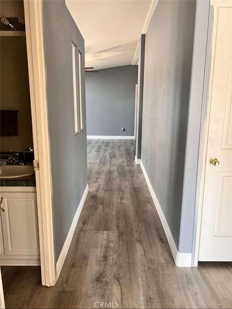 3700 Quartz Canyon Road, Unit 21 Jurupa Valley, CA 92508 - Photo 3 of 11 a view of a hallway with wooden floor and staircase