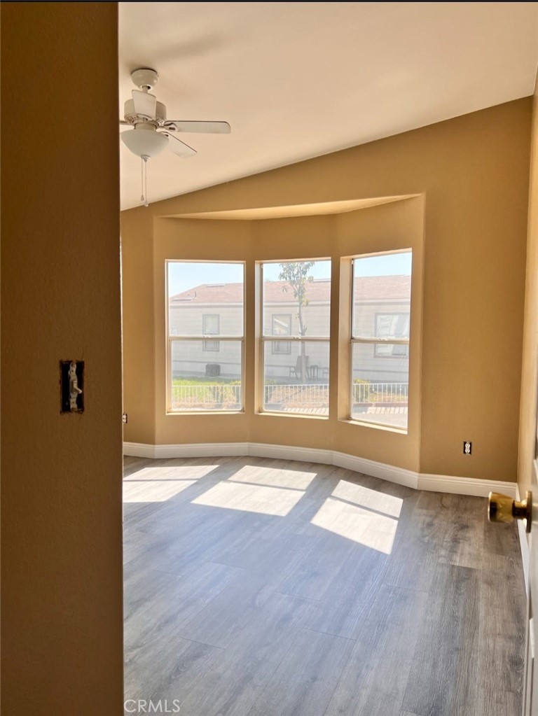 3700 Quartz Canyon Road, Unit 21 Jurupa Valley, CA 92508 - Photo 7 of 11 an empty room with wooden floor and windows