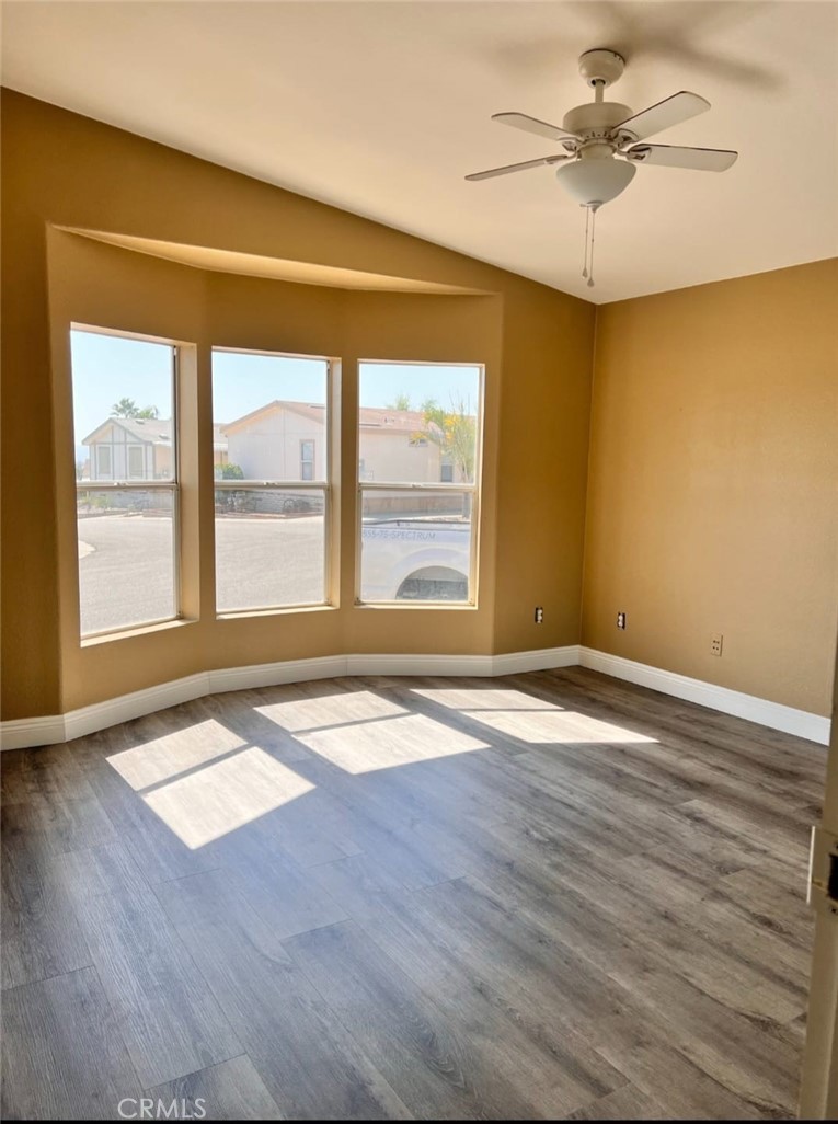 3700 Quartz Canyon Road, Unit 21 Jurupa Valley, CA 92508 - Photo 8 of 11 a view of an empty room with window and wooden floor