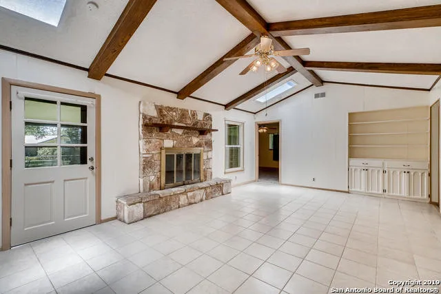 a view of a livingroom with a fireplace and window
