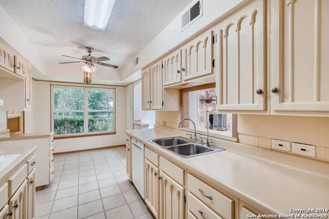 a kitchen that has a sink and a stove