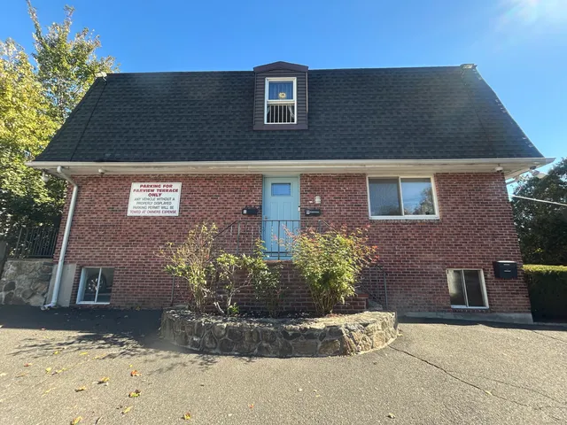 a view of a brick house with a yard