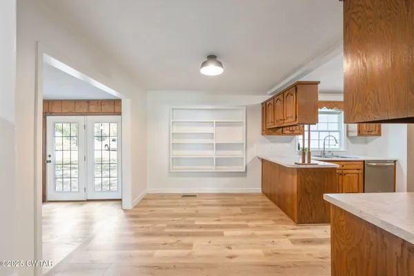 a living room with furniture and large windows