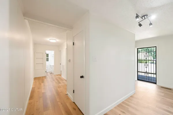 a view of room with a ceiling fan and a window
