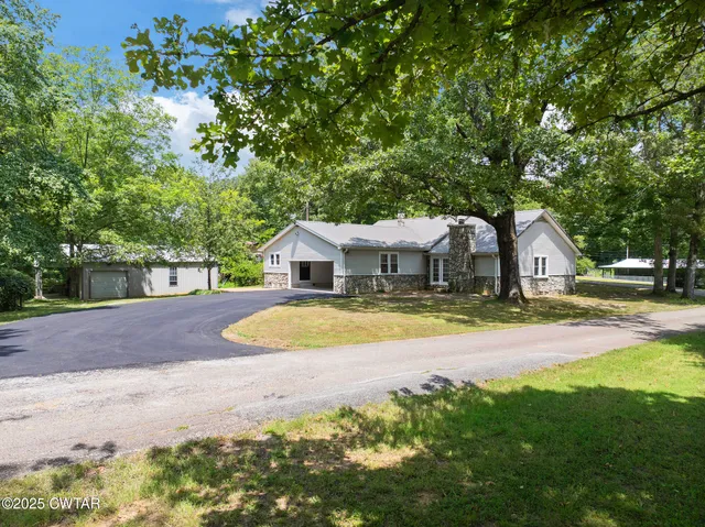 a house with swimming pool in front of it