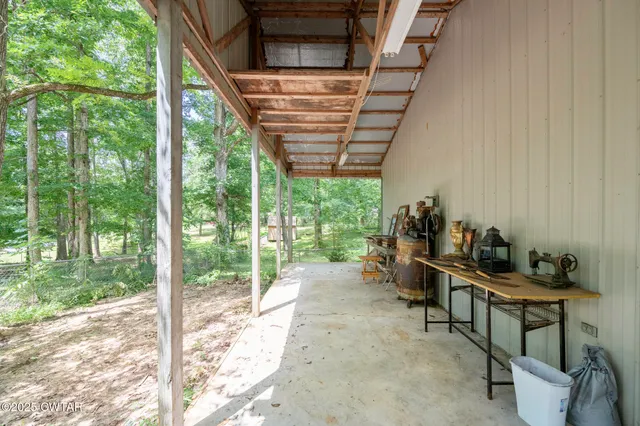 a backyard of a house with lots of plants and trees
