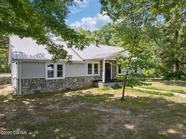 an aerial view of residential house with outdoor space and swimming pool