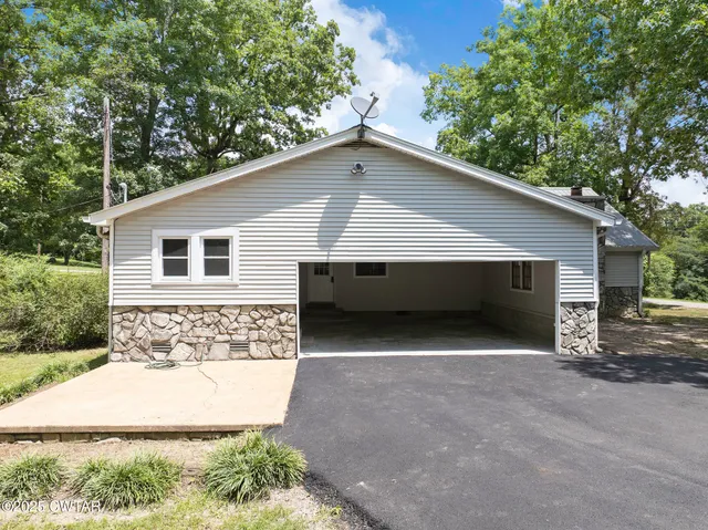 a front view of house with yard garage and garage