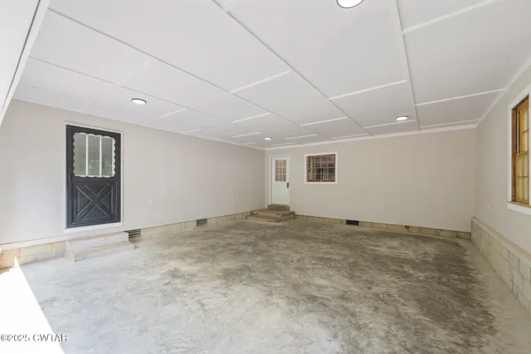 a view of an empty room with windows