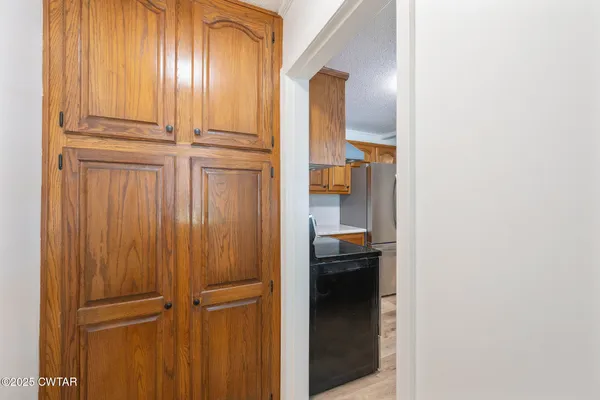 a kitchen with granite countertop stainless steel appliances and wooden cabinets