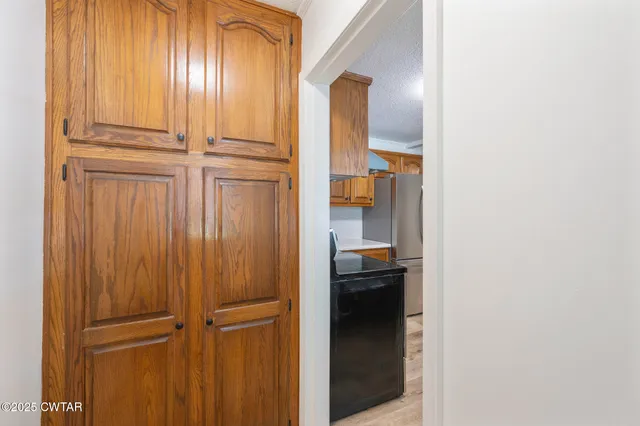 a kitchen with granite countertop stainless steel appliances and wooden cabinets