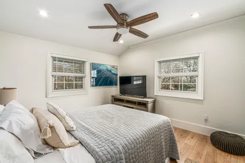 a bedroom with a large bed and a window