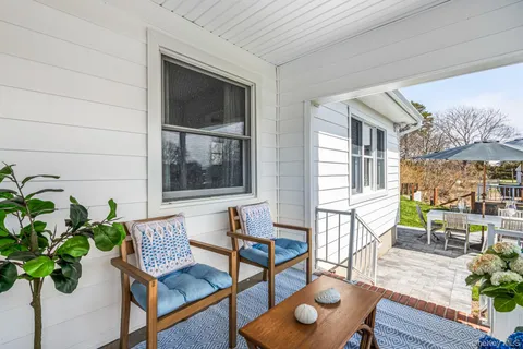 a view of a house with a backyard and a patio