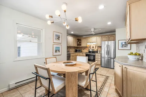 a kitchen with refrigerator cabinets dining table and chairs