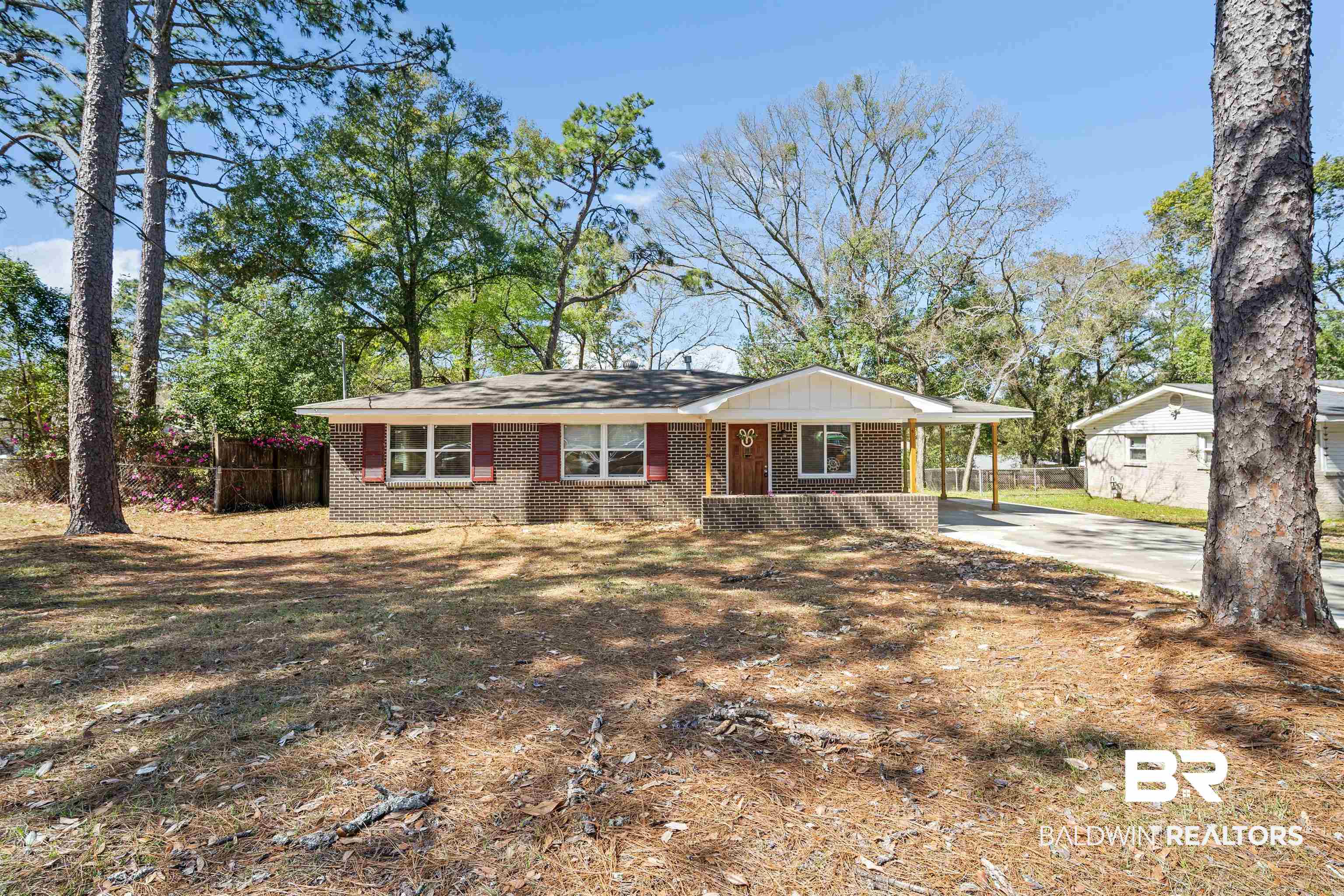 672 Tarawa Drive Mobile, AL 36609 - Photo 2 of 26 View of front of house featuring brick siding, covered porch, an attached carport, and driveway