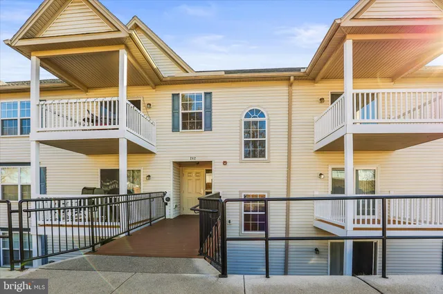a front view of a house with a iron gate