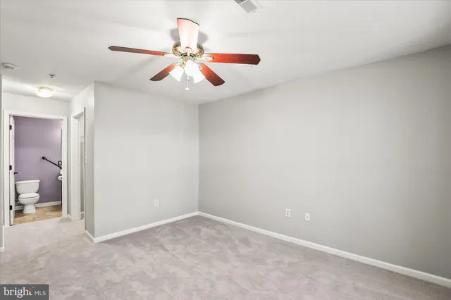 wooden floor in an empty room and a chandelier fan