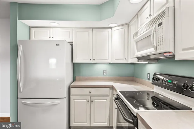 a white refrigerator freezer sitting inside of a kitchen