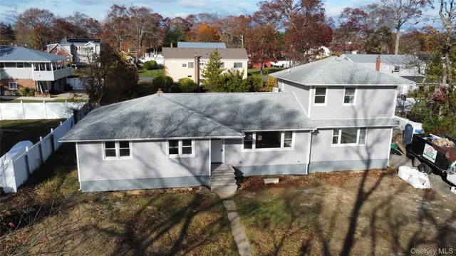 an aerial view of a house with a yard and sitting area