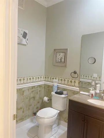 a bathroom with a toilet sink a mirror and shower