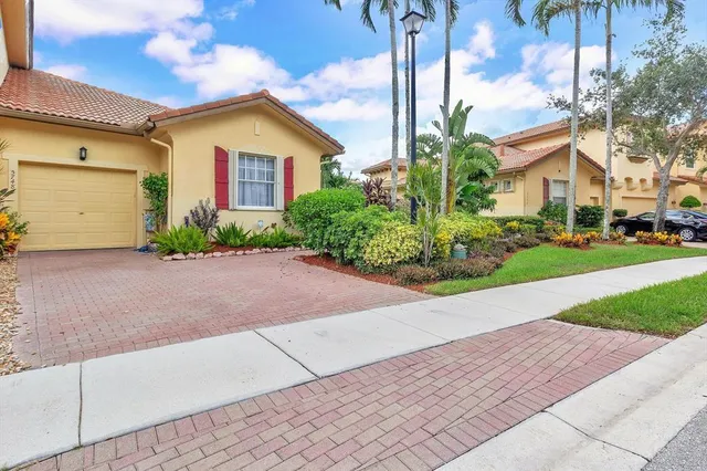 a front view of a house with a yard and a garage